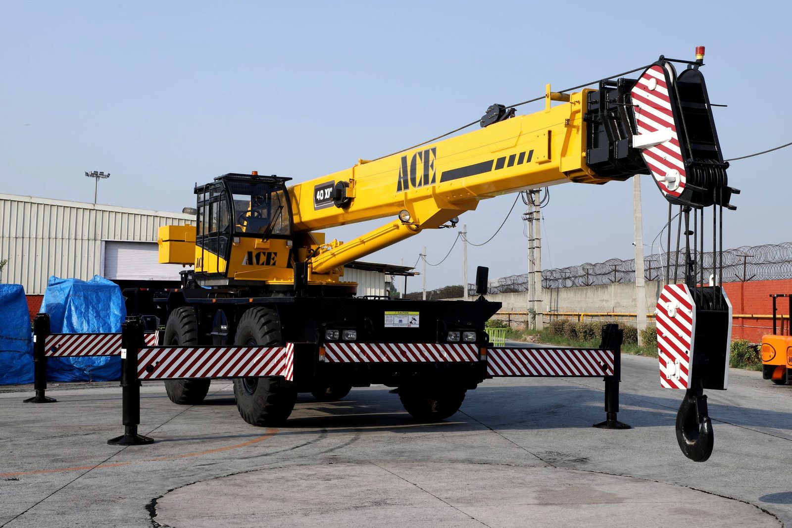 Rough-terrain mobile crane in an industrial yard (licensed stock — not RANCO's own equipment)